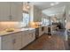 Charming kitchen featuring white cabinets, farmhouse sink, stainless appliances, and an adjacent dining area at 1648 Home Farm Rd, Mount Pleasant, SC 29464