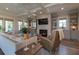 Comfortable living room featuring a stone fireplace, built-in shelving, and hardwood floors at 1648 Home Farm Rd, Mount Pleasant, SC 29464