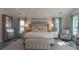 An inviting main bedroom with soft colors, a sitting area, and lots of natural light at 1648 Home Farm Rd, Mount Pleasant, SC 29464