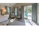 The main bedroom features a sitting chair and a balcony with views of the trees at 1648 Home Farm Rd, Mount Pleasant, SC 29464
