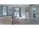 The main bedroom includes a sitting chair and access to the vanity at 1648 Home Farm Rd, Mount Pleasant, SC 29464