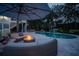 Beautiful outdoor living space with a pool, hot tub, fire pit, comfortable seating, and a large umbrella, perfect for entertaining at 1648 Home Farm Rd, Mount Pleasant, SC 29464