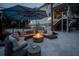Cozy outdoor patio with a fire pit, comfortable seating, and a large umbrella, perfect for evening gatherings and relaxation at 1648 Home Farm Rd, Mount Pleasant, SC 29464
