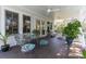 Charming covered porch with outdoor seating and lush landscaping at 1648 Home Farm Rd, Mount Pleasant, SC 29464