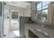 Modern shower with marble tile, a glass enclosure, and a window overlooking the outdoor deck and scenic views at 1648 Home Farm Rd, Mount Pleasant, SC 29464
