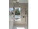 Modern shower with neutral tile and sleek hardware with a clear window offering views of the trees and sky at 1648 Home Farm Rd, Mount Pleasant, SC 29464