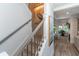 Stairway with a pelican painting leads to a living room with many windows and natural light at 1648 Home Farm Rd, Mount Pleasant, SC 29464