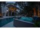 Inviting swimming pool and hot tub area features manicured landscaping and an adjacent outdoor dining area for luxurious outdoor living at 1648 Home Farm Rd, Mount Pleasant, SC 29464
