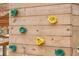 Close-up of colorful climbing holds attached to a wooden playset structure, promoting active play for  at 1742 Cultivation Ln # 531, Mount Pleasant, SC 29466