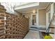 Side entrance with brick wall, small patio, and doorway with glass pane at 1769 Greenspoint Court, Mount Pleasant, SC 29466