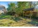 Relax on a covered swing overlooking the backyard with a decorative fountain feature at 1853 Piper Dr, Charleston, SC 29407