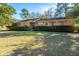 Charming brick home featuring a manicured lawn and mature landscaping offering great curb appeal at 1853 Piper Dr, Charleston, SC 29407