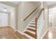 Bright entryway features hardwood floors and a staircase with wood treads and white risers at 2085 Terrabrook Ln, Charleston, SC 29412