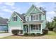 Beautiful two-story home with green siding, a manicured lawn, and an attached two-car garage at 2085 Terrabrook Ln, Charleston, SC 29412