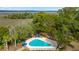 Aerial view of a pristine community pool surrounded by trees and manicured landscaping at 2119 Landfall Way, Seabrook Island, SC 29455