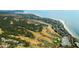 Scenic aerial view of golf course near the waterfront and houses along the coast surrounded by trees at 2119 Landfall Way, Seabrook Island, SC 29455