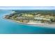 Aerial view of beachside homes, golf course, pool, and clubhouse surrounded by lush landscaping at 2119 Landfall Way, Seabrook Island, SC 29455