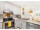 Stylish kitchen featuring stainless steel appliances, updated white cabinetry, backsplash, and granite countertops at 2119 Landfall Way, Seabrook Island, SC 29455
