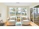 Bright sitting area with chairs, neutral walls, a view of the nature outside, and light-colored carpet flooring at 2119 Landfall Way, Seabrook Island, SC 29455