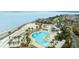 Aerial view of the pool and beach showcasing lush tropical landscaping, sunbeds, and oceanfront access at 2119 Landfall Way, Seabrook Island, SC 29455