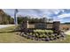 Well manicured entrance to Carolina Groves community with brick signage and beautiful landscaping at 212 Blue Haw Dr, Moncks Corner, SC 29461