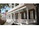 Detailed view of the home's exterior, highlighting the balconies with white columns and black shutters at 214 Calhoun St # 5, Charleston, SC 29401