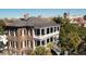 Stunning exterior view of a historic home, showcasing balconies, columns, and surrounding foliage at 214 Calhoun St # 5, Charleston, SC 29401