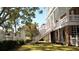 Rear exterior view of multi-story home with landscaped yard and outdoor staircases at 214 Calhoun St # 5, Charleston, SC 29401