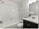 Bright bathroom featuring a shower-tub combo with white tile and a dark vanity with sink at 2362 Parsonage Rd # 17G, Charleston, SC 29414