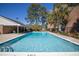 Community pool is surrounded by greenery and lounge seating at 2362 Parsonage Rd # 17G, Charleston, SC 29414