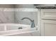 Close-up of tub fixtures and marble tiling in bathroom at 2506 Gatewood St, Charleston, SC 29492