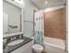 Bathroom featuring a single sink vanity with a granite countertop, toilet, and tub with a tiled surround at 2506 Gatewood St, Charleston, SC 29492