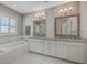 Bathroom showcasing a soaking tub, vanity, and marble tiling at 2506 Gatewood St, Charleston, SC 29492
