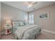 Comfortable bedroom with light blue bedding, ceiling fan and white bedside tables, offering a relaxing atmosphere at 2506 Gatewood St, Charleston, SC 29492