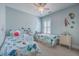 Charming bedroom with two twin beds, playful wall decorations, and a ceiling fan for comfort at 2506 Gatewood St, Charleston, SC 29492
