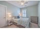 Cozy bedroom with calming color palette, ceiling fan, and a window with shutter, offering a relaxing retreat at 2506 Gatewood St, Charleston, SC 29492