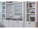 Close-up of built-in shelves with decorative items, books, and cabinet doors for storage at 2506 Gatewood St, Charleston, SC 29492