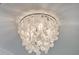 Stunning close-up of the capiz shell chandelier on the ceiling at 2506 Gatewood St, Charleston, SC 29492