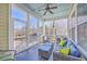 Relaxing covered porch features comfortable seating and a ceiling fan for breezy outdoor enjoyment at 2506 Gatewood St, Charleston, SC 29492