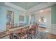 Light-filled dining room features an oval wood table with seating for eight, decorative rug and wainscoting at 2506 Gatewood St, Charleston, SC 29492