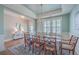 Elegant dining room with hardwood floors, stylish rug, wainscoting and abundant natural light from plantation shutters at 2506 Gatewood St, Charleston, SC 29492