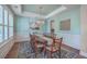 Stylish dining room showcases wood floors, a chandelier, and a serene wall color, with beautiful art on the walls at 2506 Gatewood St, Charleston, SC 29492