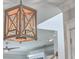 Close-up of a wood-framed pendant light fixture hanging from a white ceiling with crown molding at 2506 Gatewood St, Charleston, SC 29492
