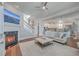Open-concept living room with fireplace, plush sofa, and stairs leading to the upper level at 2506 Gatewood St, Charleston, SC 29492