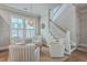 A bright living room space with four chairs surrounding a round table and stairway at 2506 Gatewood St, Charleston, SC 29492