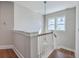 Staircase featuring white railings, wooden steps and a hanging pendant light at 2506 Gatewood St, Charleston, SC 29492