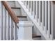 Close-up of a staircase with white wooden rails and brown wood handrail, showcasing craftsmanship at 2506 Gatewood St, Charleston, SC 29492