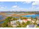 An aerial view of the property that overlooks a marsh, with views of the city skyline in the background at 26 Saturday Rd, Mount Pleasant, SC 29464