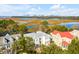 Aerial view of the neighborhood showcasing beautiful homes and waterfront access with cranes in the distance at 26 Saturday Rd, Mount Pleasant, SC 29464