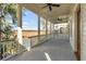 Covered balcony with wood railing and ceiling fans offers relaxing marsh views at 26 Saturday Rd, Mount Pleasant, SC 29464